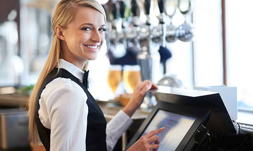 Till operator standing at the EPoS