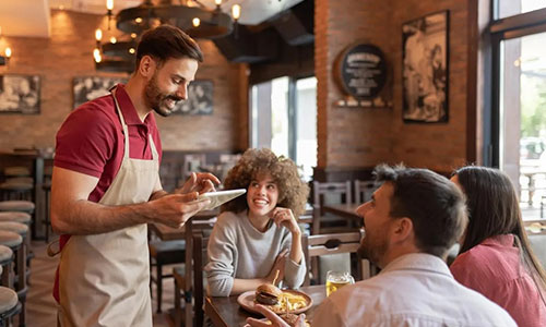 Waiter taking an order at the table
