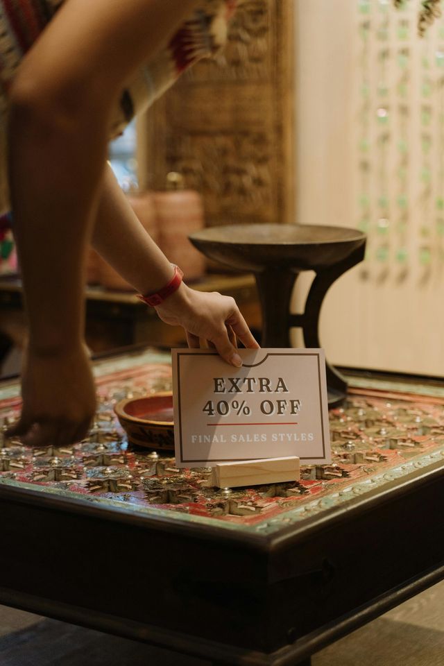Shop worker displaying promotional offer
