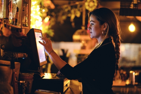 Woman using a touchscreen EPoS System