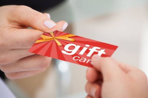 Cashier presenting customer with a gift card