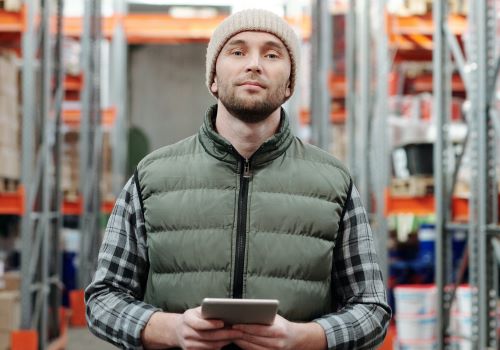 Worker booking goods into his stockroom